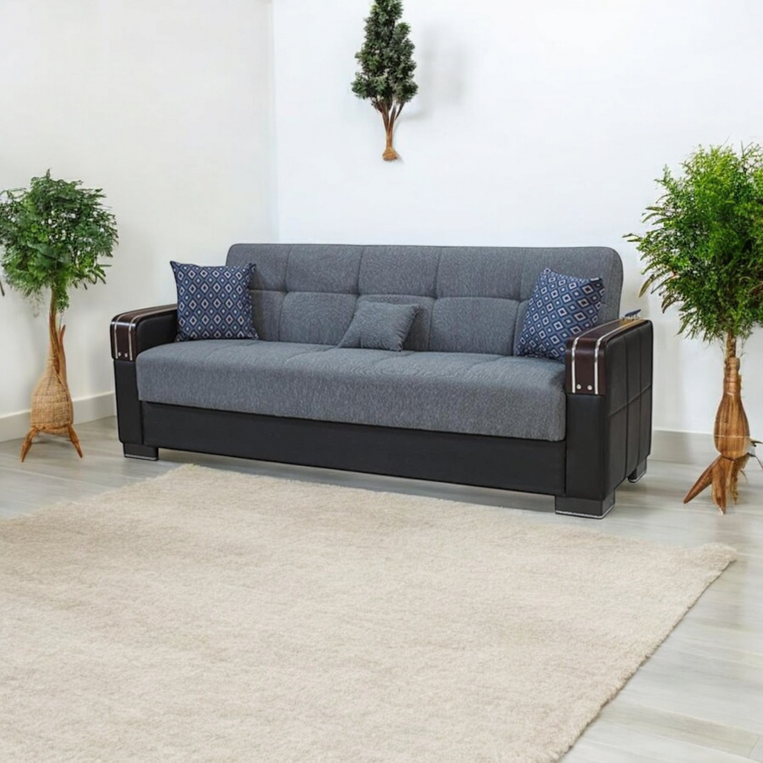 Gray 3 seater sofa bed with blue patterned cushions 