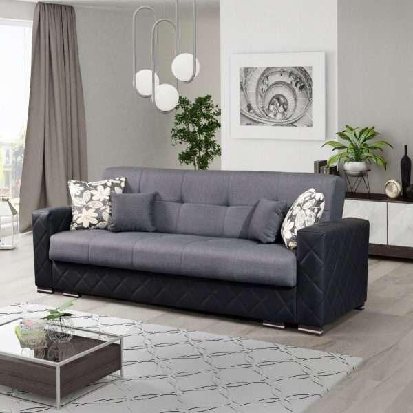 Gray sofa with black accents and floral-patterned cushions 