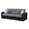 Gray sofa with black accents and floral-patterned cushions 